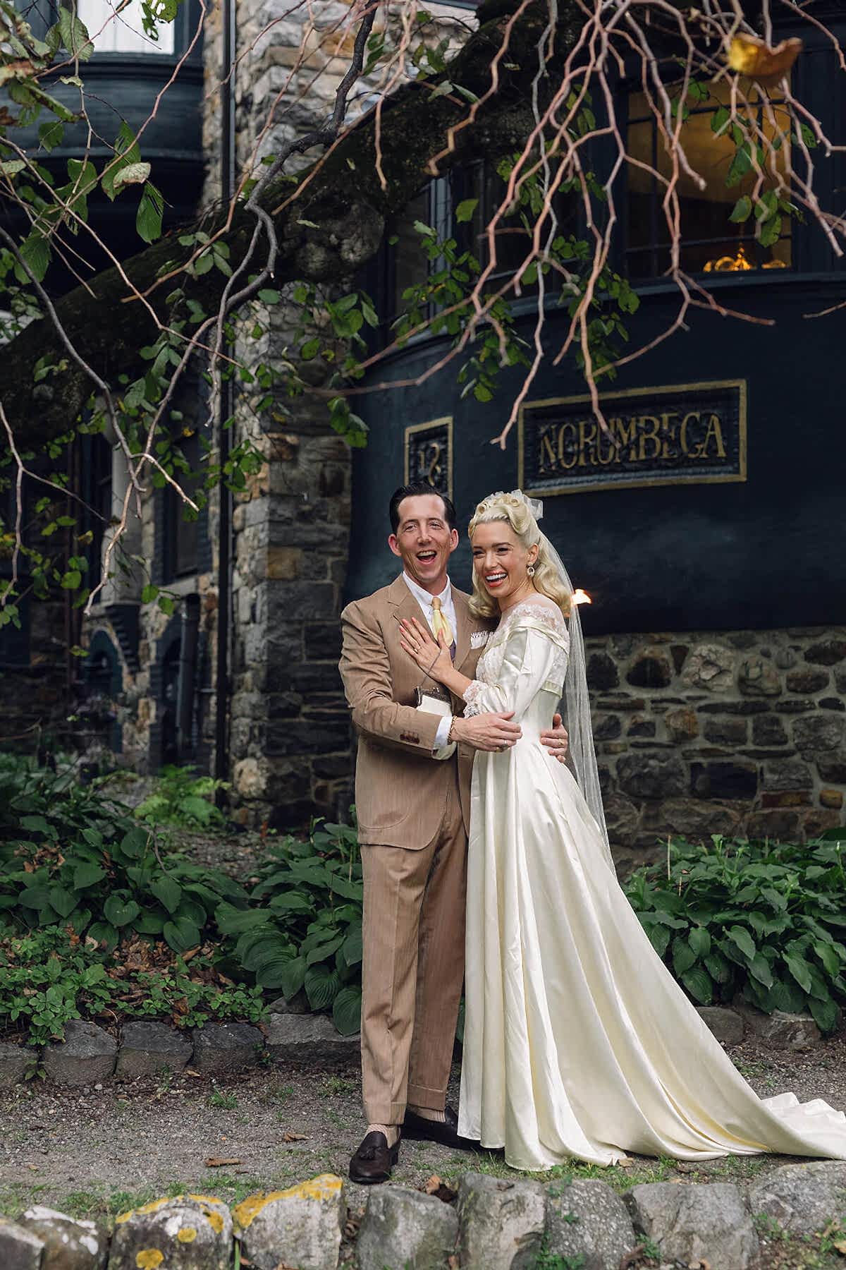 Bride and Groom posing in front of The Norumbega